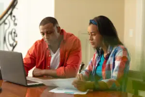 An African American couple planning their website