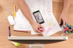 A man looking over papers and creating a marketing plan
